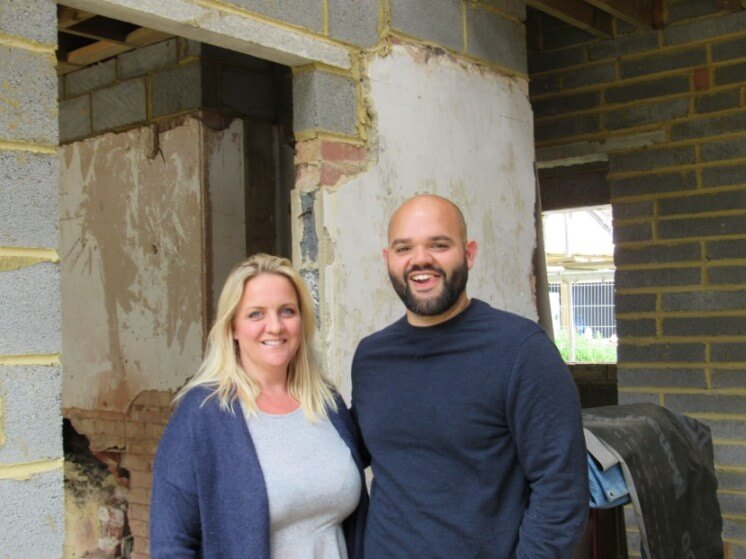 Daryl and Hannah inside their build with one of the original interior walls showing
