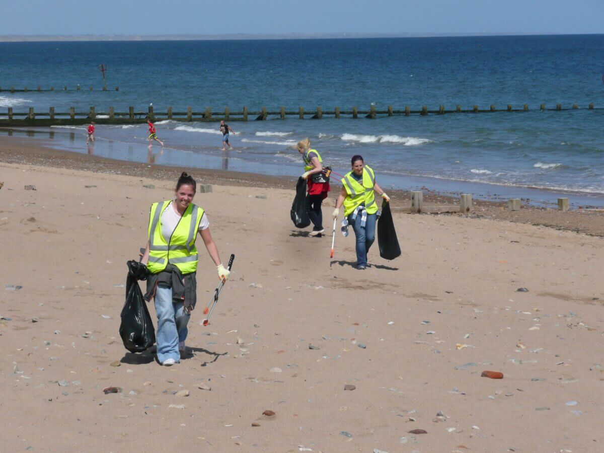Sea-Changers volunteers picking up litter on a beach