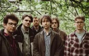 Rivers and Lakes jazz collective in a woodlands looking directly at the camera